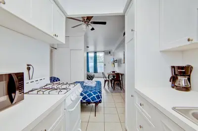 a kitchen with white cabinets and a stove top oven at Ocean Drive Best Deal, w/2 Queen Beds, Near Beach in Miami Beach