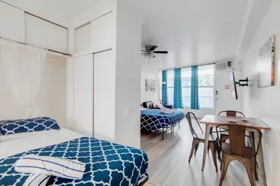a bedroom with a bed and a table and chairs at Ocean Drive Best Deal, w/2 Queen Beds, Near Beach in Miami Beach