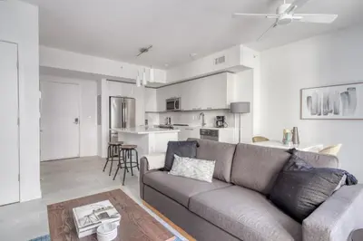 a living room with a couch and a kitchen at Wynwood 1br w gym pool wd nr shops bars MIA-34 in Miami