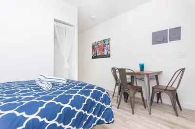 a bedroom with a bed and a table and chairs at Ocean Drive Deco Apt w/2 Queen Beds, Steps 2 Beach in Miami Beach