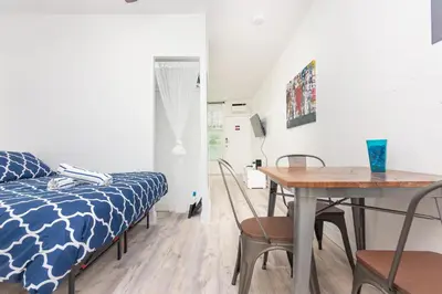a room with a bed and a table and a dining room at Ocean Drive Deco Apt w/2 Queen Beds, Steps 2 Beach in Miami Beach