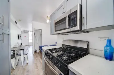 a kitchen with a stove and a microwave at Steps 2 Beach, Ocean Drive Deco Apt w/2 Queen Beds in Miami Beach
