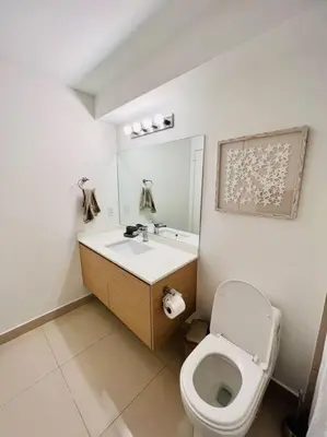 a bathroom with a toilet and a sink at Soñada vista al agua 3/3 in Miami