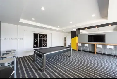 a room with a pool table and a flat screen tv at Soñada vista al agua 3/3 in Miami