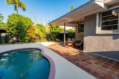 a swimming pool in the backyard of a house at Surfers Cove - Modern 3 2 w Pool near Calle 8 in Miami