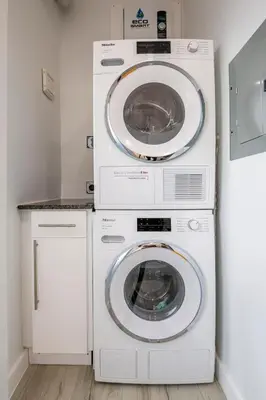 two washing machines and a washer and dryer in a room at Surfers Cove - Modern 3 2 w Pool near Calle 8 in Miami