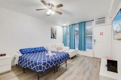 a bedroom with a bed and a ceiling fan at Super Beach Deal, Apt w/2 Queen Beds On Ocean Dr in Miami Beach