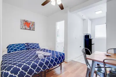 a bedroom with a blue comforter on a bed at Stylish Ocean Dr Apt w/ 2 Queen Beds, Across Beach in Miami Beach