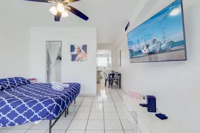 a bedroom with a bed and a painting on the wall at Sunny Ocean Dr Condo, w/2 Queen Beds, South Beach in Miami Beach
