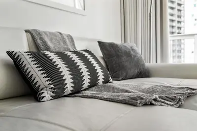 a couch with two pillows on it with a window at Modern High Rise One Bedroom at Icon Brickell (W) in Miami