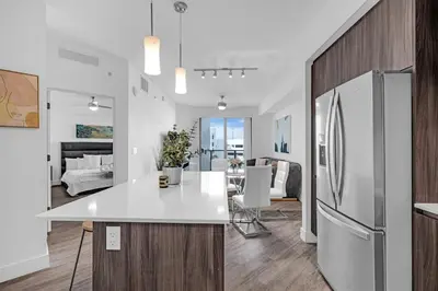 a kitchen and living room with a refrigerator at Tranquil 1 Bed Escape in Doral With Free Parking in Hialeah Gardens