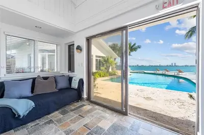 a living room with a couch and a view of the ocean at Villa Hashmi Luxury 5BD & 5BA Retreat on North Bay Island in Miami Beach