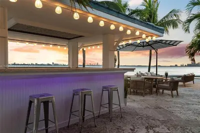 a bar on the beach with a view of the ocean at Villa Hashmi Luxury 5BD & 5BA Retreat on North Bay Island in Miami Beach