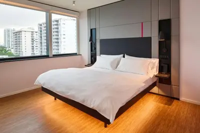 a bedroom with a large bed with a large window at citizenM Miami South Beach in Miami Beach