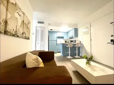 a living room with a couch and a table at Miami International Airport 1 in Miami