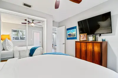 a bedroom with a bed and a flat screen tv at Wilton Manors 2BR Charm! Walk to the Drive in Fort Lauderdale