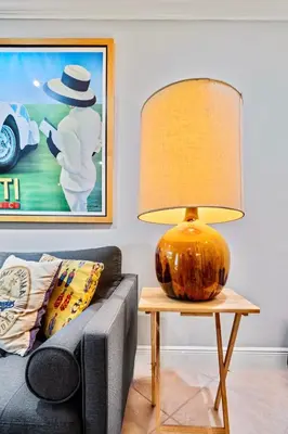a lamp on a table next to a couch at Wilton Manors 2BR Charm! Walk to the Drive in Fort Lauderdale