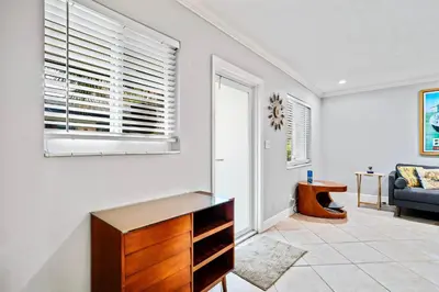a living room with a dresser and a window at Wilton Manors 2BR Charm! Walk to the Drive in Fort Lauderdale