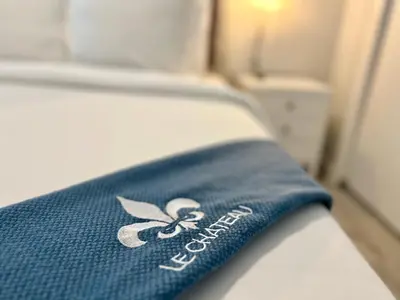 a blue towel on a bed in a room at Wilton Manors 2BR Charm! Walk to the Drive in Fort Lauderdale