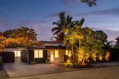 a house with palm trees in front of it at Walk to Wilton Drive - Spacious & Quiet Villa #2 HOT TUB! in Fort Lauderdale