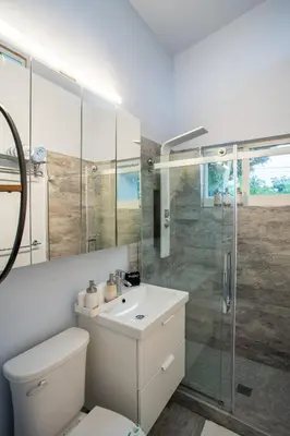 a bathroom with a toilet and a sink and a shower at Walk to Wilton Drive - Spacious & Quiet Villa #2 HOT TUB! in Fort Lauderdale