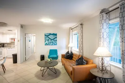 a living room with a couch and two tables at Walk to Wilton Drive - Spacious & Quiet Villa #1 in Fort Lauderdale