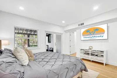 a white bedroom with a bed and a couch at Villa Tropicale Stunning 4 Bedroom 4 Bath Home with Pool and BBQ in Miami