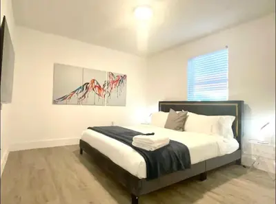 a bedroom with a bed and a painting on the wall at Miami International Airport 2 in Miami