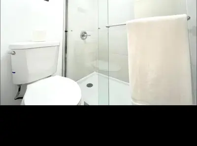 a bathroom with a white toilet and a shower at Miami International Airport 2 in Miami