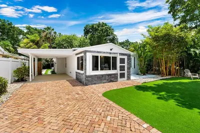 a house with a green lawn in front of it at Perfect FLL Location with Putting Green in Fort Lauderdale