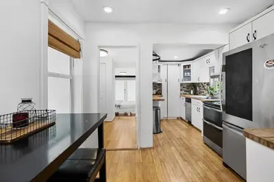 a kitchen with white walls and a black counter top at Perfect FLL Location with Putting Green in Fort Lauderdale