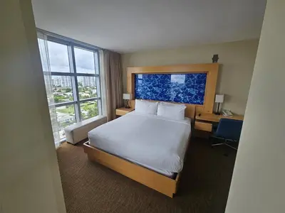 a hotel room with a bed and a desk and window at Mare-1708 A in Aventura