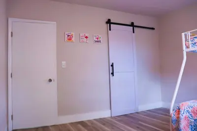 a room with a white door and a bed at Flamingo Beach House in Dania Beach