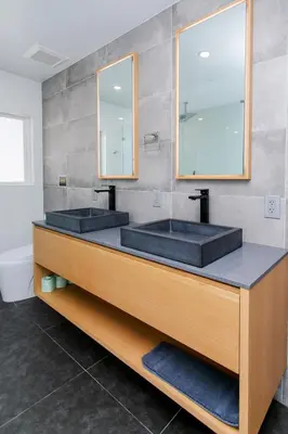a bathroom with two sinks and two mirrors at Premium Luxury 5BR & 3BA Villa near Hollywood Beach in Hollywood
