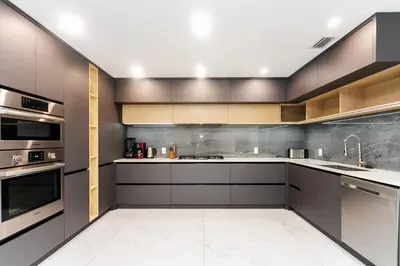 a kitchen with gray cabinets and stainless steel appliances at Premium Luxury 5BR & 3BA Villa near Hollywood Beach in Hollywood