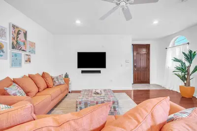 a living room with a couch and a flat screen tv at Center Grove - Lush & Spacious & New - 3 Bedrooms in Miami