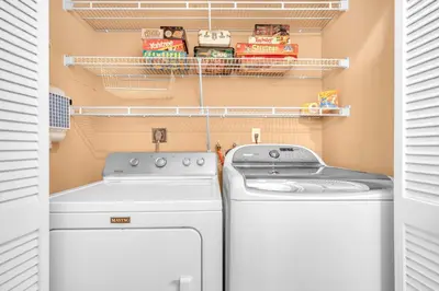 a laundry room with a washer and dryer at Center Grove - Lush & Spacious & New - 3 Bedrooms in Miami