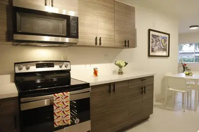 a kitchen with a stove and a microwave at Apt 2 Miami Designer Apartment in the Upper East-Side in Miami