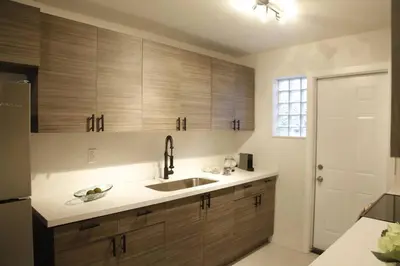 a kitchen with wooden cabinets and a sink at Apt 2 Miami Designer Apartment in the Upper East-Side in Miami