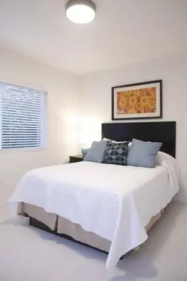 a white bedroom with a large white bed in it at Apt 2 Miami Designer Apartment in the Upper East-Side in Miami