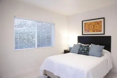 a white bedroom with a bed and a window at Apt 3 Miami Designer Apartment in the Upper East-Side in Miami