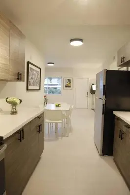 a kitchen with a refrigerator and a table in it at Apt 3 Miami Designer Apartment in the Upper East-Side in Miami