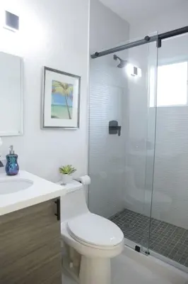 a bathroom with a toilet and a glass shower at Apt 5 Miami Designer Apartment in the Upper East-Side in Miami
