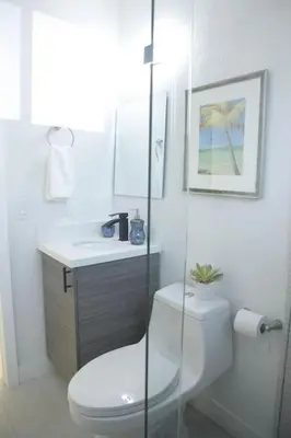 a white bathroom with a toilet and a sink at Apt 5 Miami Designer Apartment in the Upper East-Side in Miami