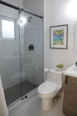 a bathroom with a toilet and a glass shower at Apt 6 Miami Designer Studio in the Upper East-Side in Miami