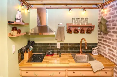 a kitchen with a sink and a counter top at Miami Tiny Vintage Cottage in Hialeah