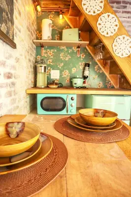 a kitchen with wooden plates on a wooden floor at Miami Tiny Vintage Cottage in Hialeah
