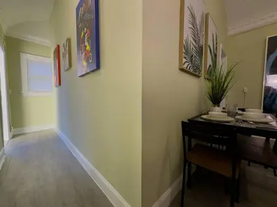 a dining room with a table and a dining roomiasm at Shenandoah Victorian Suite with TV's in every room in Miami