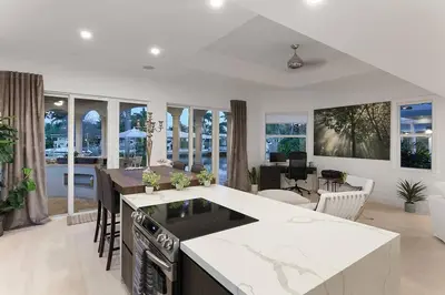 a kitchen and living room with an island in a house at Infinity Luxury Waterfront Infinity Pool and Hot Tub SLEEPS 8 in Fort Lauderdale