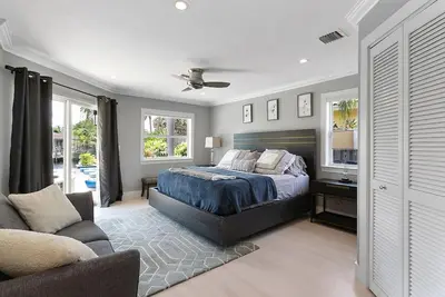 a large bedroom with a bed and a couch at Infinity Luxury Waterfront Infinity Pool and Hot Tub SLEEPS 8 in Fort Lauderdale